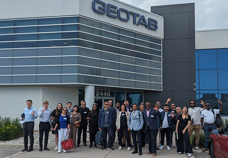 Collision Conference familiarization tour Group of people in front of the Geotab building.