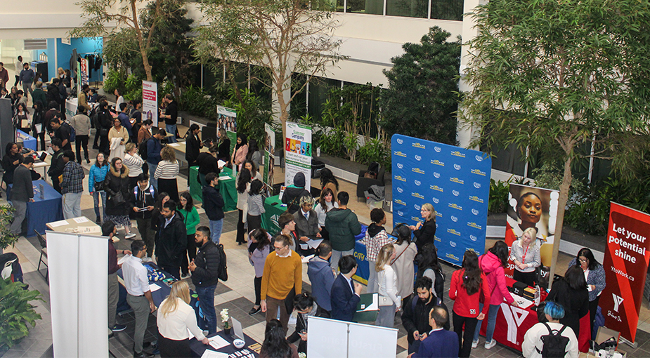 Student Job Fair booths set up in the Town Hall Atrium and youth walking around